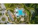 Aerial view of resort-style pool next to the condos and a serene pond surrounded by lush greenery at 2975 Yachtsman Dr, Mount Pleasant, SC 29466