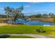 Picturesque waterfront backyard with a lush lawn, wooden bridge, and comfortable seating at 2975 Yachtsman Dr, Mount Pleasant, SC 29466