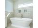 Close up of a modern standalone tub with tile backsplash and window in a bright bathroom at 2975 Yachtsman Dr, Mount Pleasant, SC 29466
