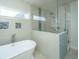 A bright bathroom features a standalone tub and a walk-in shower with glass doors and decorative tile at 2975 Yachtsman Dr, Mount Pleasant, SC 29466