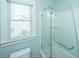Bright bathroom featuring a glass-enclosed shower and a large window at 2975 Yachtsman Dr, Mount Pleasant, SC 29466