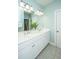 Bathroom boasts dual sinks, a large mirror, white cabinets and lots of natural light at 2975 Yachtsman Dr, Mount Pleasant, SC 29466