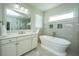 A bright bathroom features a standalone tub, double vanity with a mirror, tile accents, and a window at 2975 Yachtsman Dr, Mount Pleasant, SC 29466