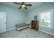 Light-filled bedroom features a ceiling fan, neutral carpet and a wooden bookcase at 2975 Yachtsman Dr, Mount Pleasant, SC 29466