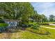 Welcoming entrance to Dunes West with lush landscaping and a brick sign at 2975 Yachtsman Dr, Mount Pleasant, SC 29466