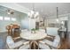 Bright dining area with hardwood floors, stylish table, and an adjacent piano room for elegant living at 2975 Yachtsman Dr, Mount Pleasant, SC 29466