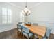 Bright dining room features a wood table, wainscoting, and a decorative chandelier at 2975 Yachtsman Dr, Mount Pleasant, SC 29466
