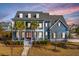 Charming blue two-story home with a welcoming front porch and meticulously maintained landscaping at 2975 Yachtsman Dr, Mount Pleasant, SC 29466