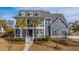 Beautifully landscaped two-story home with a spacious front porch and classic architectural details at 2975 Yachtsman Dr, Mount Pleasant, SC 29466