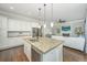 A chef's kitchen with a large granite island, stainless steel appliances, and a view of the cozy living area at 2975 Yachtsman Dr, Mount Pleasant, SC 29466