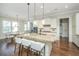 An open kitchen featuring a granite island with barstool seating and elegant pendant lighting at 2975 Yachtsman Dr, Mount Pleasant, SC 29466