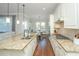 A chef's kitchen featuring a large granite island and seamlessly connecting to the dining and living areas at 2975 Yachtsman Dr, Mount Pleasant, SC 29466