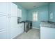 Well-lit laundry room featuring stainless steel washer/dryer and abundant storage at 2975 Yachtsman Dr, Mount Pleasant, SC 29466