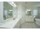 Elegant main bathroom with marble countertops, dual sinks, modern lighting, and tiled floors at 2975 Yachtsman Dr, Mount Pleasant, SC 29466