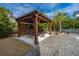 Outdoor patio with a pergola, a TV, an outdoor table with chairs, string lights, a fire pit, and decorative landscaping at 2975 Yachtsman Dr, Mount Pleasant, SC 29466