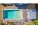Captivating aerial shot of a crystal-clear swimming pool, set in a stone-paved patio with fire-pit at 2975 Yachtsman Dr, Mount Pleasant, SC 29466