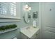 Stylish powder room featuring marble countertop vanity, modern lighting, and plantation shutters at 2975 Yachtsman Dr, Mount Pleasant, SC 29466