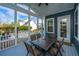 Cozy screened porch with dining table and comfortable seating for relaxation at 2975 Yachtsman Dr, Mount Pleasant, SC 29466