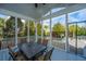 Charming screened porch with large table, chairs, and views of the backyard at 2975 Yachtsman Dr, Mount Pleasant, SC 29466