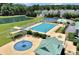 A neighborhood aerial featuring a pool, splash pad, playground, lake, and tennis courts promotes community living at 301 Forsythia Ave, Summerville, SC 29483