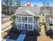 Stunning aerial view of the two story home with a charming front porch and palm trees at 301 Forsythia Ave, Summerville, SC 29483
