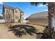 Backyard view with a well-maintained lawn, a matching detached garage, and white fence at 301 Forsythia Ave, Summerville, SC 29483
