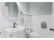 Half bathroom with a white pedestal sink, mirror, and toilet at 301 Forsythia Ave, Summerville, SC 29483