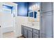 Well-lit bathroom with gray vanity, white countertops, and a shower-tub combination for a clean, modern look at 301 Forsythia Ave, Summerville, SC 29483