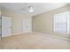 Empty bedroom features a ceiling fan, natural light, and neutral walls at 301 Forsythia Ave, Summerville, SC 29483