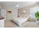 Comfortable bedroom with a ceiling fan, natural light, and neutral decor at 301 Forsythia Ave, Summerville, SC 29483