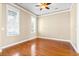 Unfurnished bedroom features hardwood floors, large windows, a ceiling fan, and neutral paint at 301 Forsythia Ave, Summerville, SC 29483