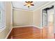 Unfurnished bedroom boasts hardwood floors, natural light, and an open doorway to another room at 301 Forsythia Ave, Summerville, SC 29483