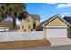 Charming house with a detached garage, white picket fence, and well-manicured lawn, perfect for suburban living at 301 Forsythia Ave, Summerville, SC 29483