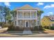 Charming two-story home featuring a double porch, landscaped yard, and palm trees at 301 Forsythia Ave, Summerville, SC 29483