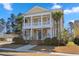 Charming two-story home featuring a double porch, landscaped yard, and palm trees at 301 Forsythia Ave, Summerville, SC 29483
