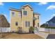 Charming two-story home with yellow siding, white trim, and large windows, showcasing its inviting curb appeal at 301 Forsythia Ave, Summerville, SC 29483