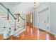 Inviting foyer featuring hardwood floors, a chandelier, and an accessible stair lift at 301 Forsythia Ave, Summerville, SC 29483