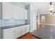 Well-lit kitchen features white cabinets, gray countertops, and stainless steel appliances at 301 Forsythia Ave, Summerville, SC 29483
