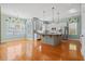 Open kitchen with stainless appliances, large island, white cabinets and lots of room to move around at 301 Forsythia Ave, Summerville, SC 29483