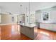 Modern kitchen and island with an open concept floor plan, stainless appliances, and hardwood floors at 301 Forsythia Ave, Summerville, SC 29483
