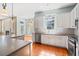 Open kitchen with stainless appliances, a center island, and white cabinets at 301 Forsythia Ave, Summerville, SC 29483