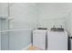 A tidy laundry room featuring a washer, dryer, and shelving for ample storage, creating an organized space at 301 Forsythia Ave, Summerville, SC 29483
