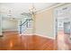 Open-concept living room with hardwood floors, chandelier lighting, and access to other rooms at 301 Forsythia Ave, Summerville, SC 29483