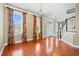 Spacious living room featuring hardwood floors, chandelier lighting, and large windows at 301 Forsythia Ave, Summerville, SC 29483