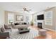 Well-decorated living room features a fireplace, hardwood floors, lots of light, and comfortable furniture at 301 Forsythia Ave, Summerville, SC 29483