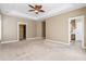 Spacious bedroom with tray ceilings, a ceiling fan, and neutral paint at 301 Forsythia Ave, Summerville, SC 29483