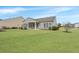 Spacious, well-maintained backyard featuring a covered porch and ample green space at 303 Sand Dune Trl, Summerville, SC 29486