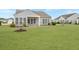 A spacious yard surrounds this home with large windows to bring the outside in at 303 Sand Dune Trl, Summerville, SC 29486