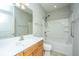 Bathroom featuring a wood vanity, a large mirror and a shower-tub combo with safety bars at 303 Sand Dune Trl, Summerville, SC 29486