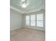 Bedroom boasts trey ceiling, carpet, and multiple windows with blinds at 303 Sand Dune Trl, Summerville, SC 29486